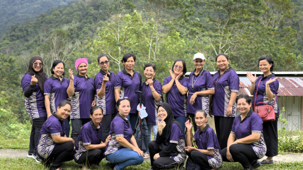 A joyful group of women entrepreneurs in Kiulu, Sabah, posing casually with smiles and confident expressions.