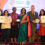 A group of individuals holding awards and certificates.